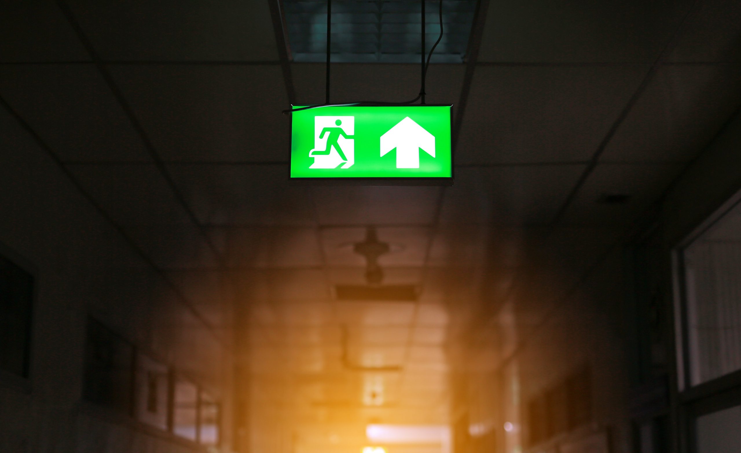 green emergency exit sign in public building.
