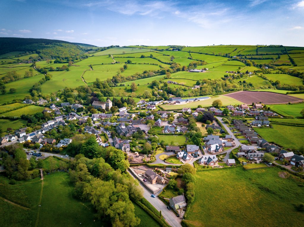 Aerial view above houses in an old British village in the country